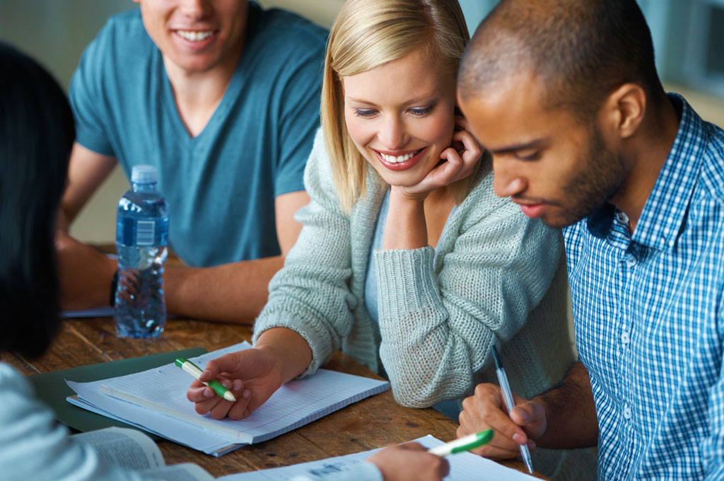 Group of people working together, mixed gender, taking notes